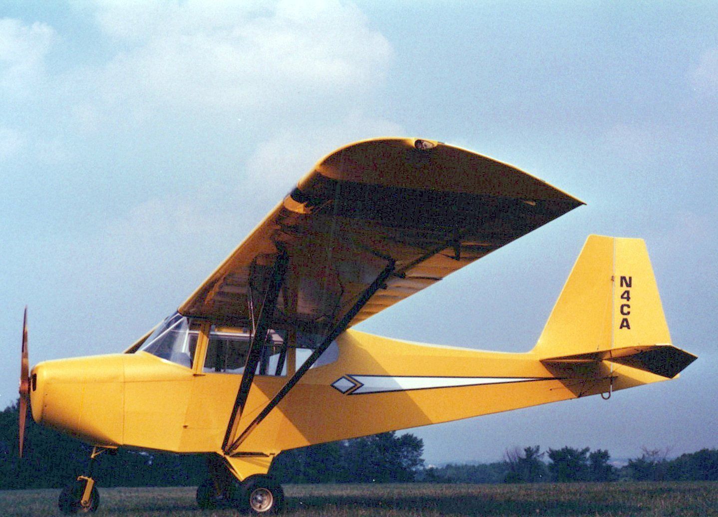 Yellow Carlson Sparrow II XTC demonstrator N4CA parked on grass