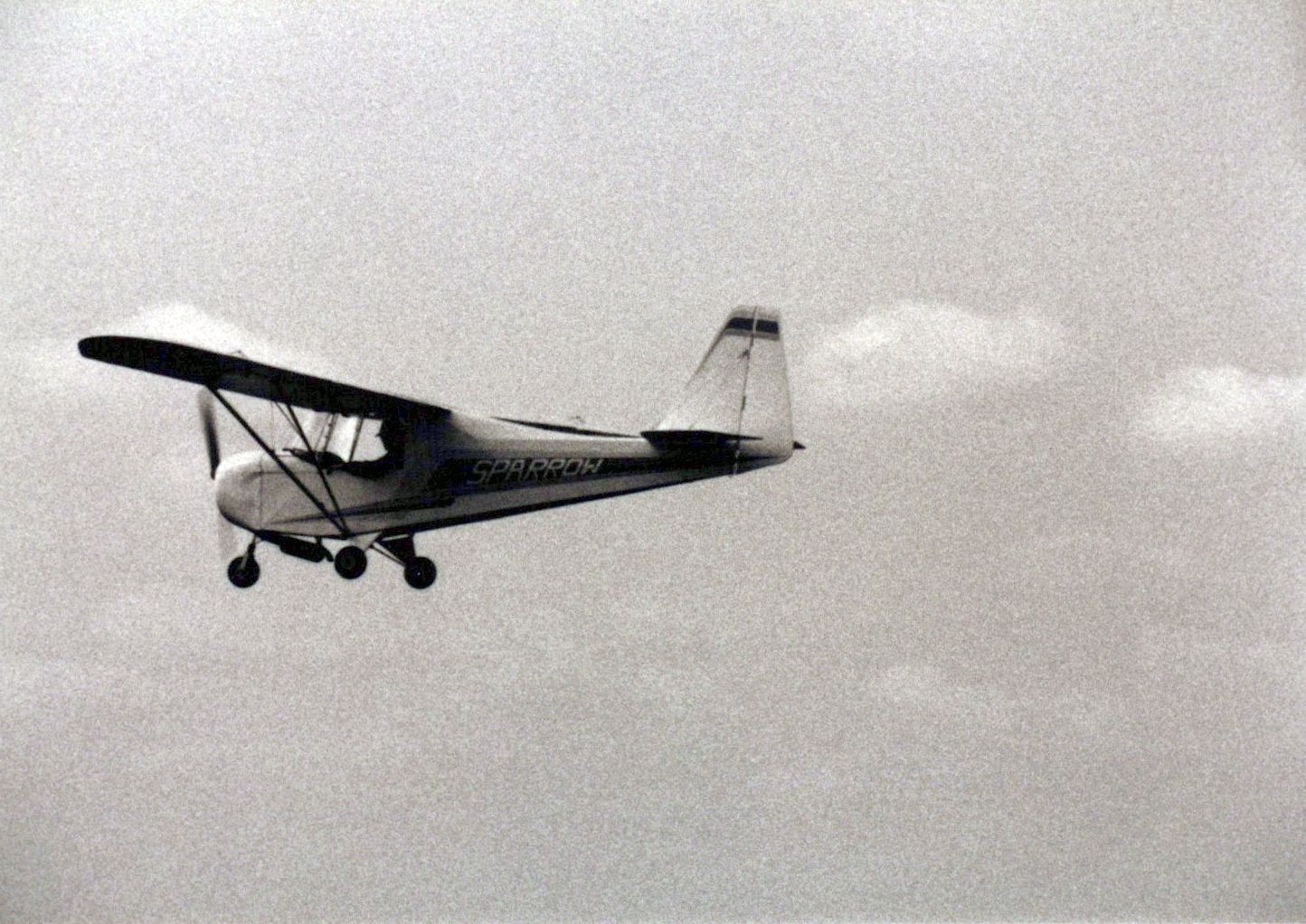 Grainy black-and-white print of a Carlson Sparrow in flight
