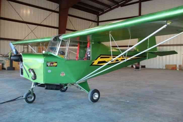Green owner-built Carlson Sparrow parked in a hangar