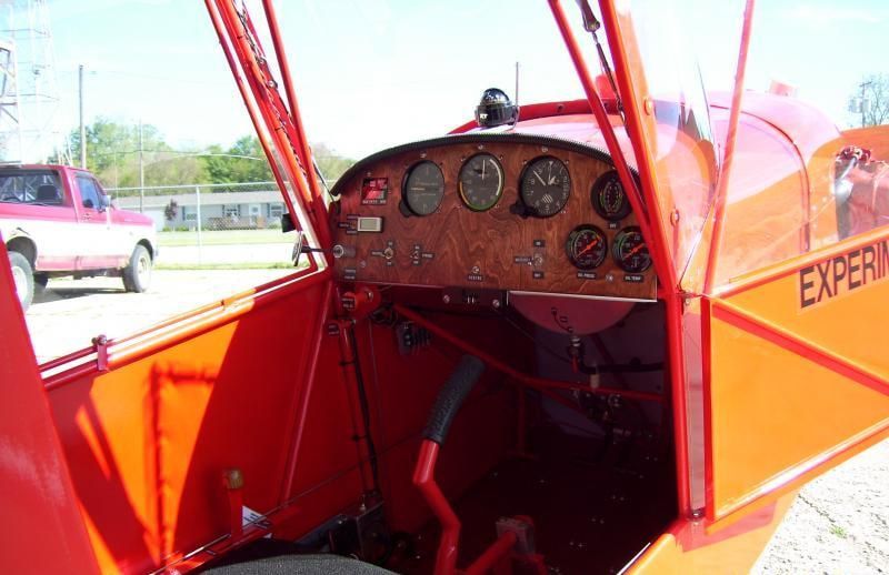 Cockpit interior of a red Carlson Sparrow Sport Special with the door open