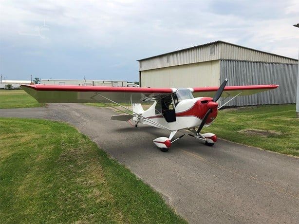 Carlson Sparrow Sport Special on a taxiway between hangars