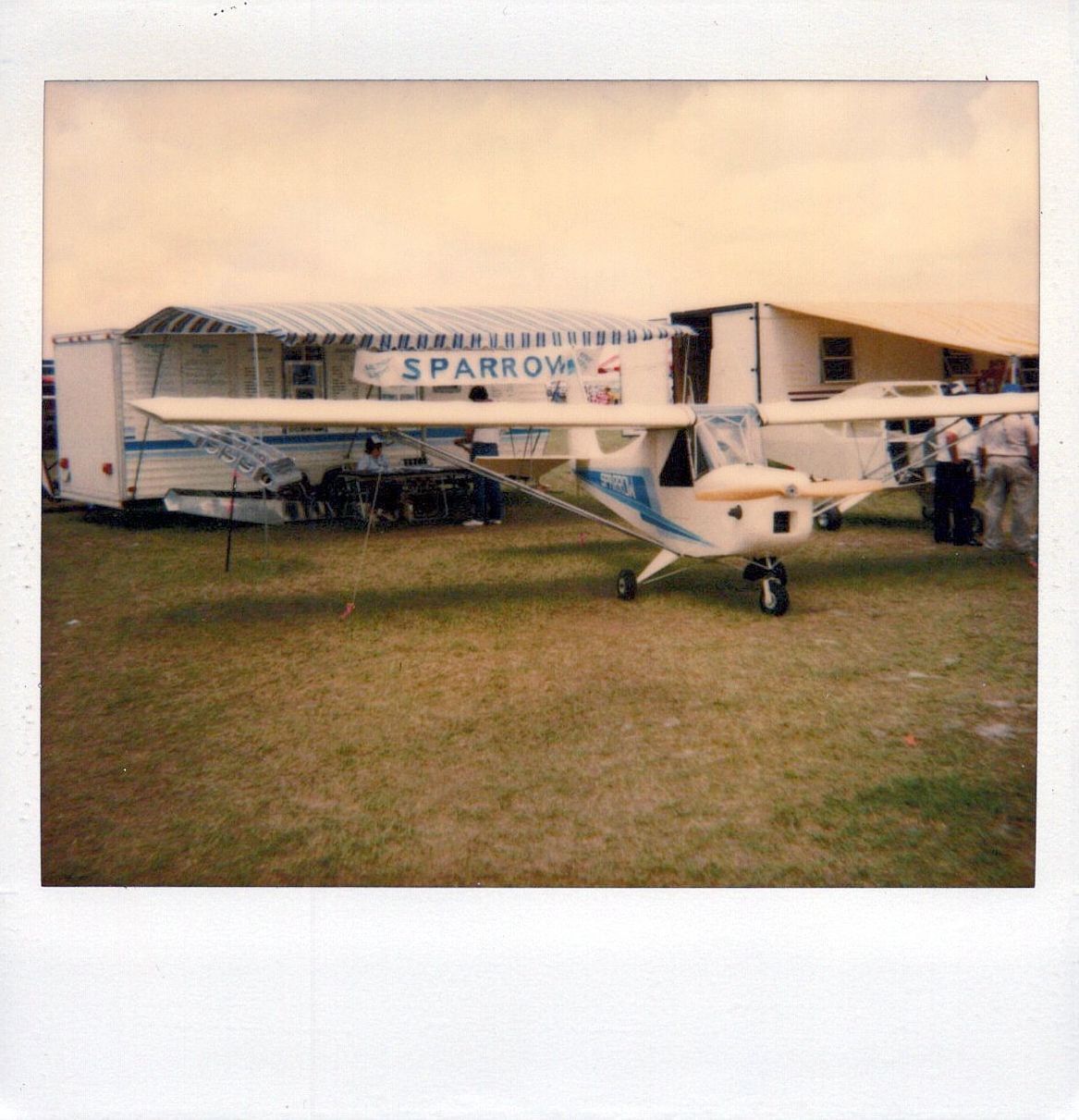 Instant photograph of the Carlson Sparrow trailer display with a Sparrow parked beside it