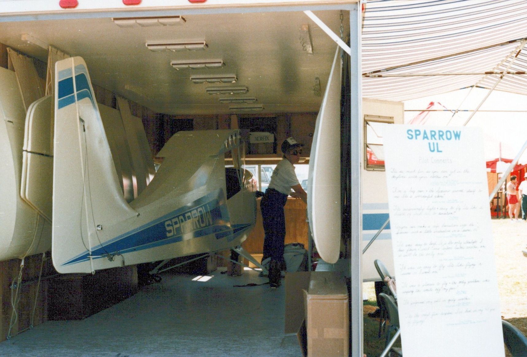 Carlson Sparrow UL fuselage displayed inside an open trailer with an information sign