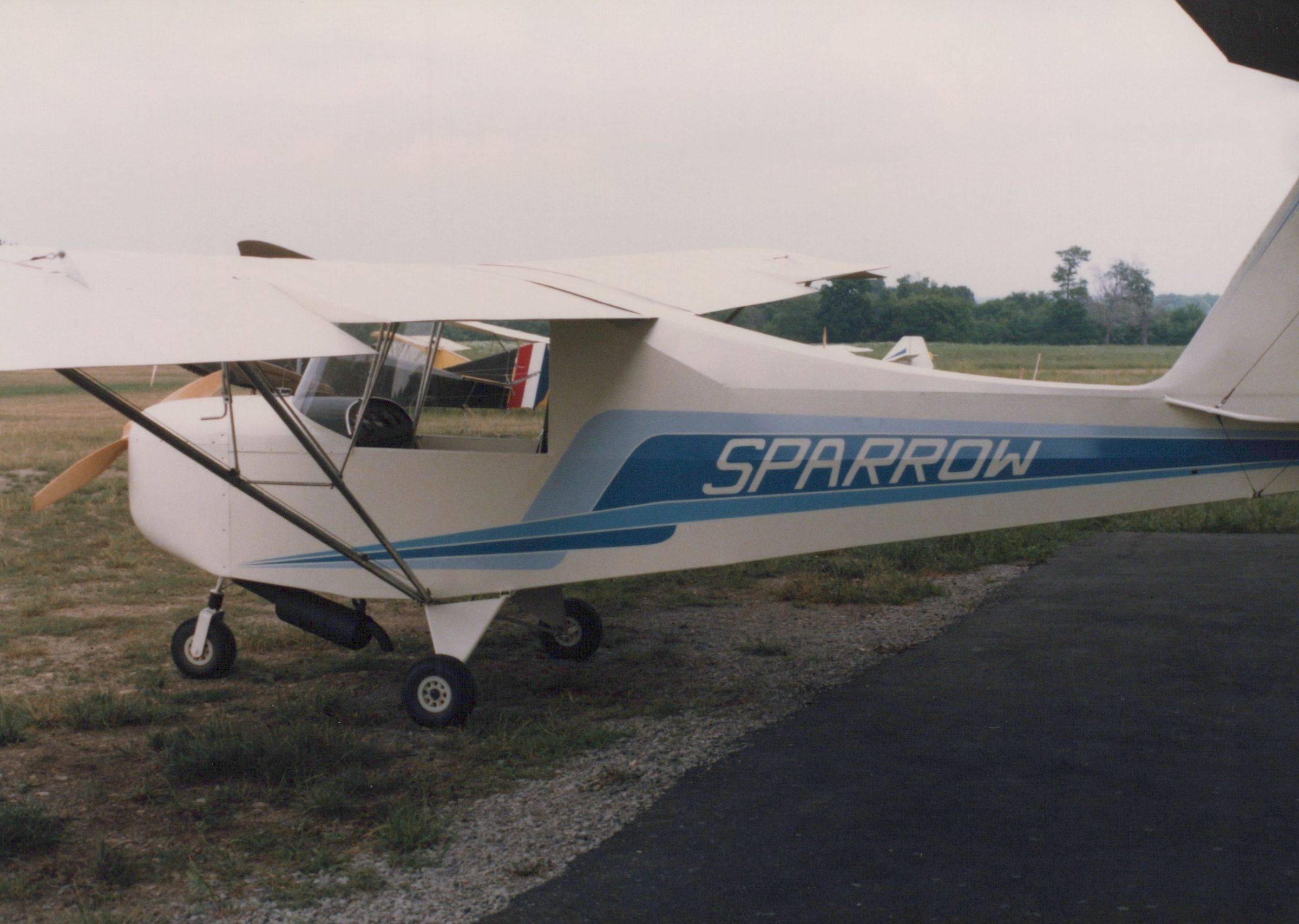 Close side view of a Carlson Sparrow Ultralight with Sparrow lettering on the fuselage