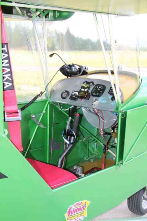 Enclosed single-seat cockpit of a green Carlson Sparrow Ultralight