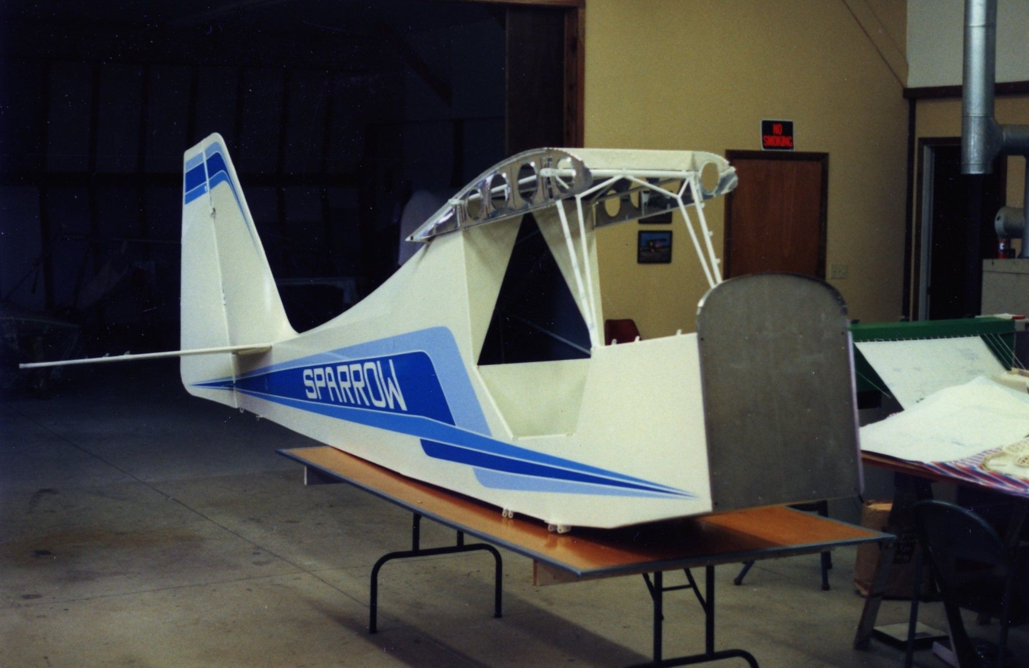 Carlson Sparrow Ultralight on display indoors with its wing structure left uncovered