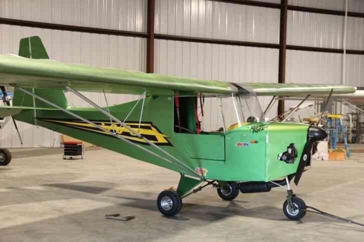 Green owner-built Carlson Sparrow Ultralight in a hangar