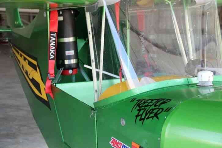 Close-up of the nose and cockpit side of a green owner-built Carlson Sparrow Ultralight